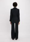 Person wearing a black suit on a white background