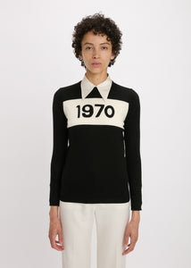 Person wearing a black and white sweater with '1970' print on a white background